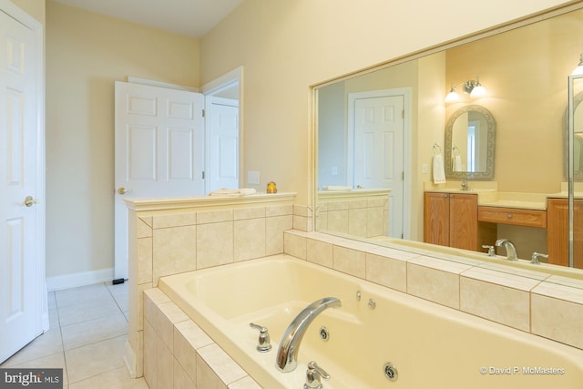 bathroom with a relaxing tiled tub, vanity, and tile patterned flooring