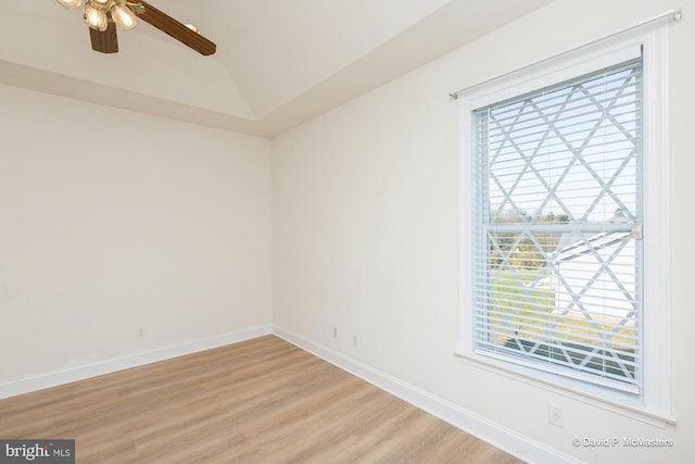 unfurnished room with lofted ceiling, a wealth of natural light, ceiling fan, and light hardwood / wood-style flooring