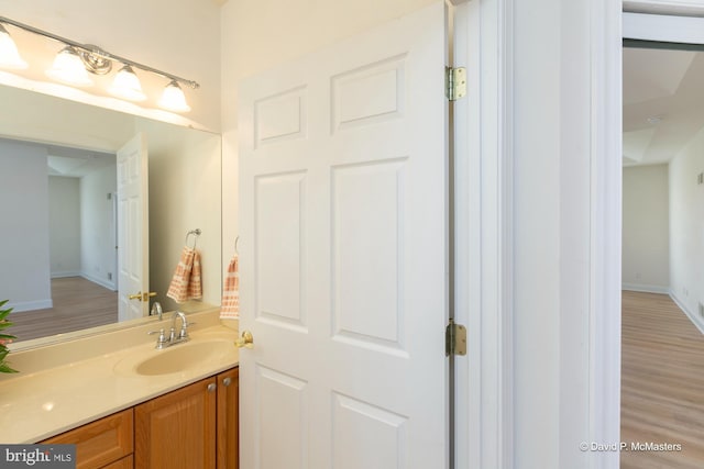 bathroom featuring vanity and wood-type flooring