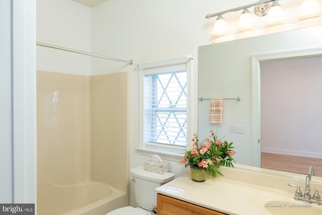 full bathroom featuring vanity, bathing tub / shower combination, and toilet