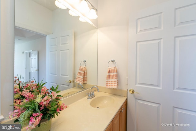 bathroom with vanity and a chandelier