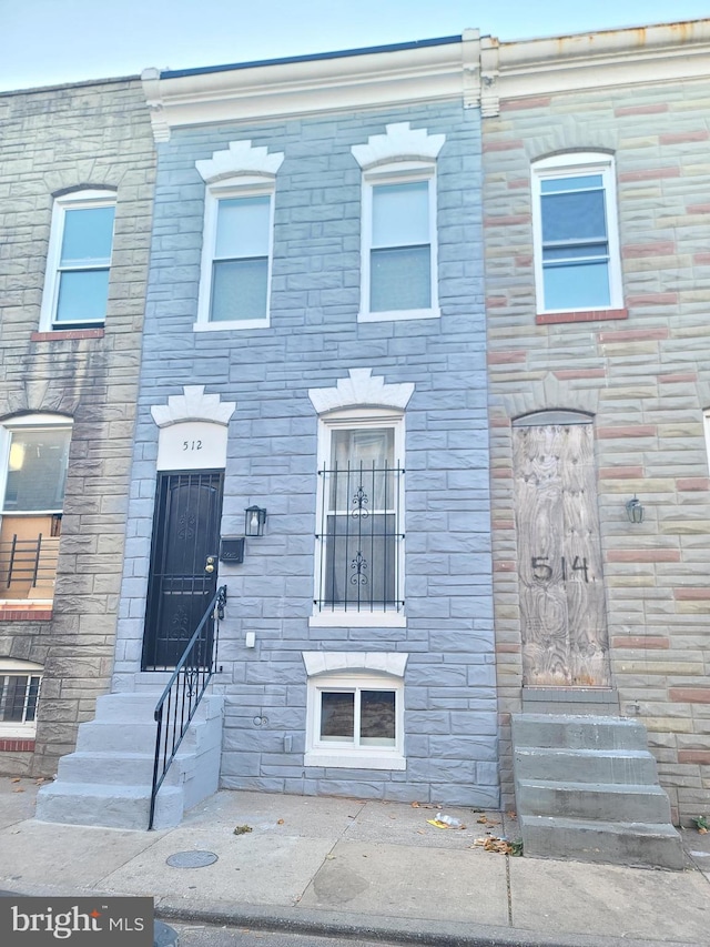 view of property featuring entry steps and stone siding