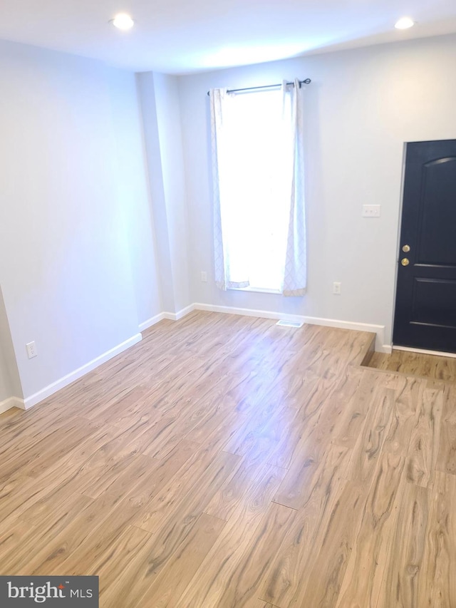 foyer featuring recessed lighting, baseboards, and wood finished floors