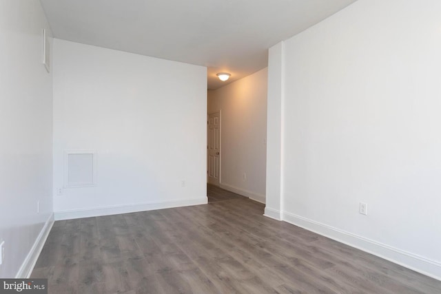 empty room with dark wood-type flooring