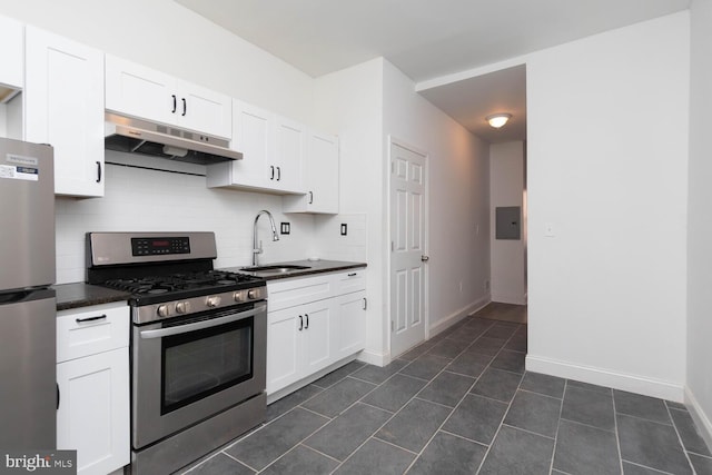 kitchen featuring backsplash, appliances with stainless steel finishes, sink, and white cabinets