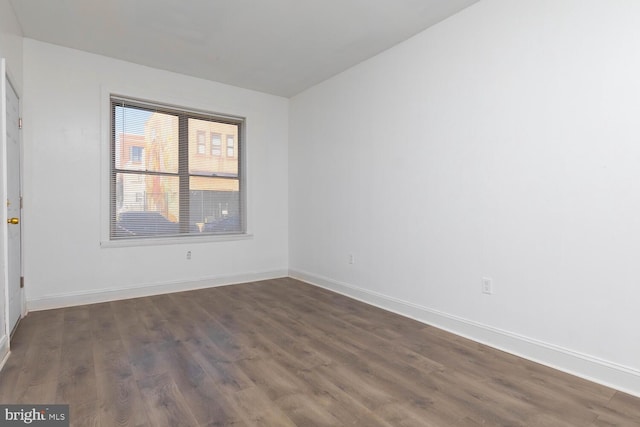 spare room with dark hardwood / wood-style floors