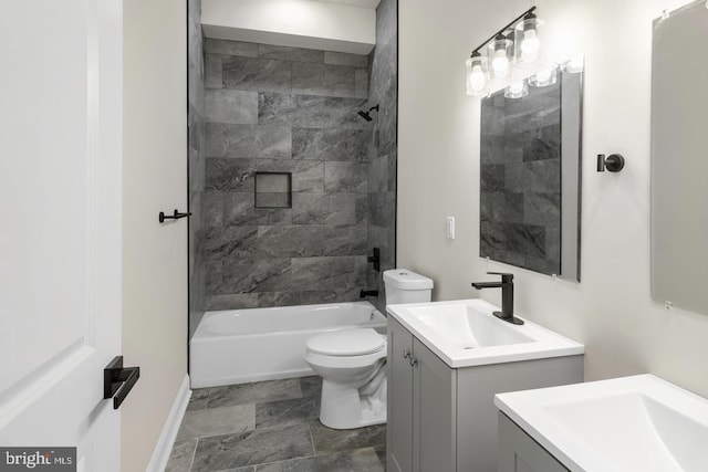 full bathroom featuring vanity, toilet, and tiled shower / bath