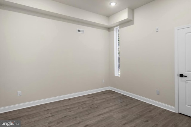 spare room with dark wood-type flooring