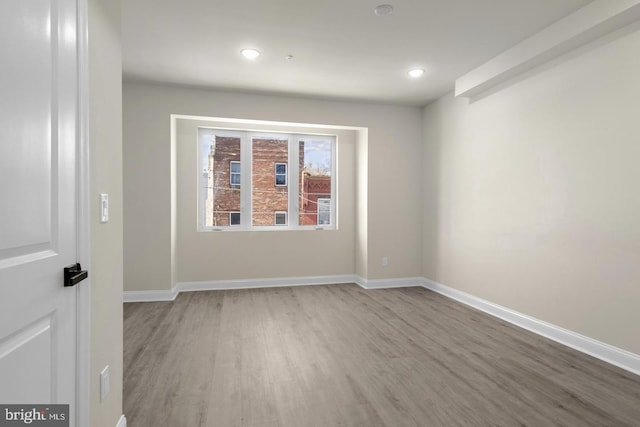 unfurnished room with wood-type flooring