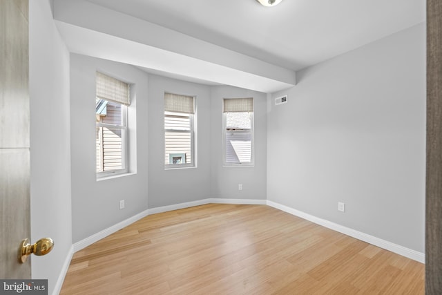 spare room featuring light wood-type flooring