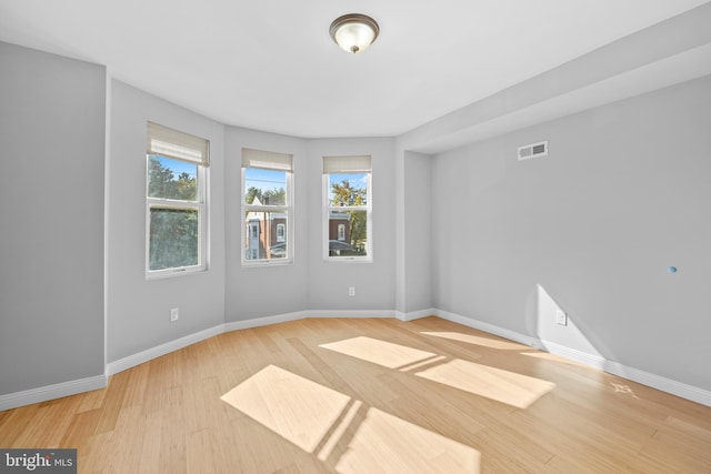 spare room featuring light hardwood / wood-style flooring