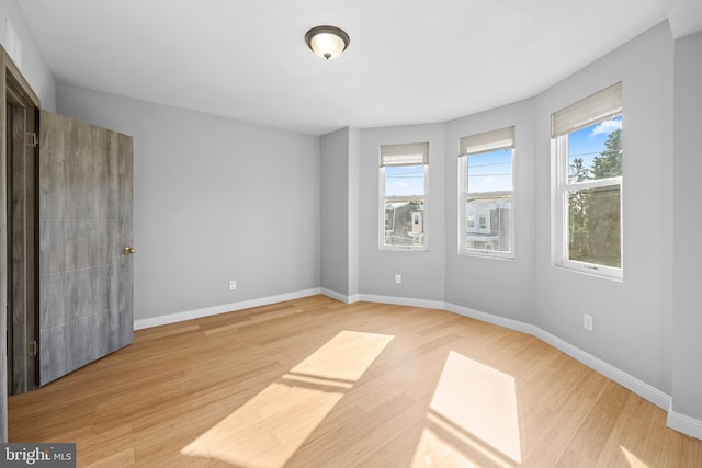 unfurnished room with light wood-type flooring