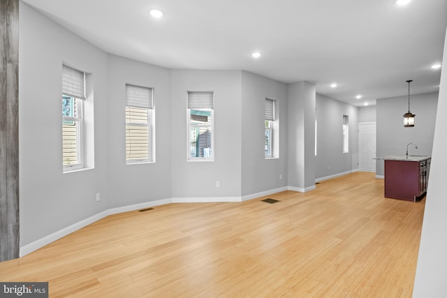 unfurnished living room featuring light wood-type flooring