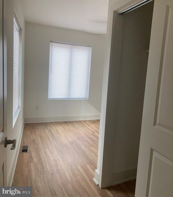 unfurnished room with light hardwood / wood-style floors and a healthy amount of sunlight