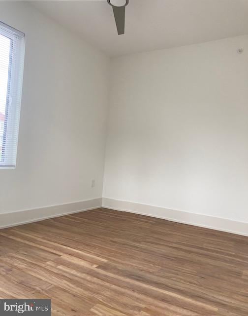 empty room featuring wood-type flooring and ceiling fan