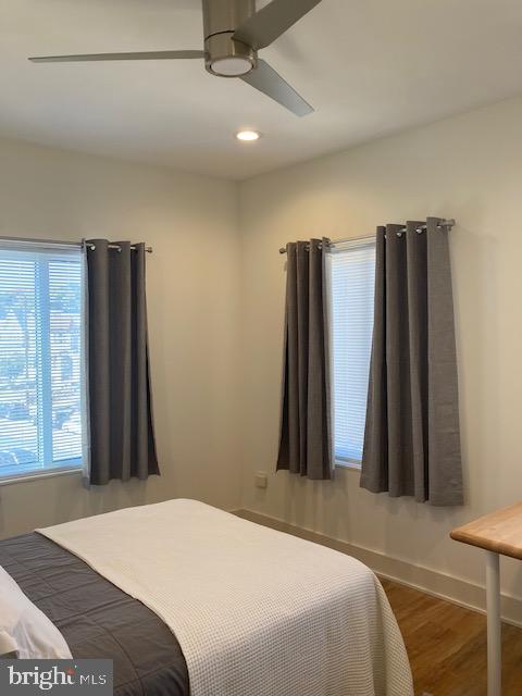 bedroom with dark wood-type flooring and ceiling fan