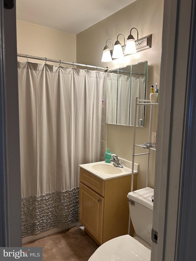 bathroom with vanity, a shower with curtain, and toilet