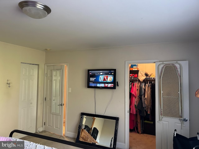5601 Parker House Ter Unit 407, Hyattsville, MD 20782 - carpeted bedroom featuring baseboards, a spacious closet, and a closet