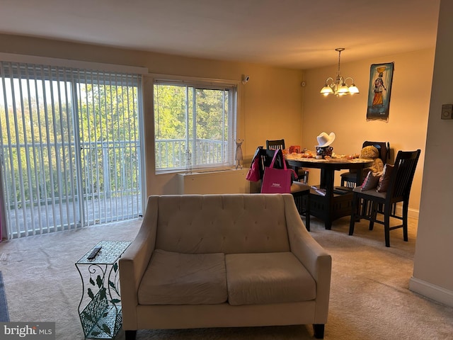 living room featuring a notable chandelier and carpet flooring