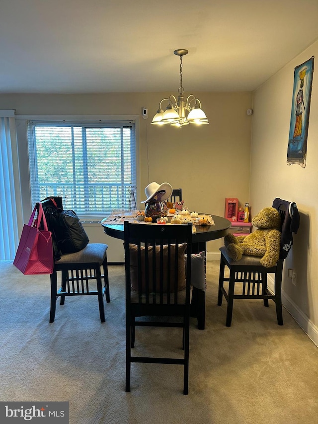 carpeted dining space featuring a chandelier