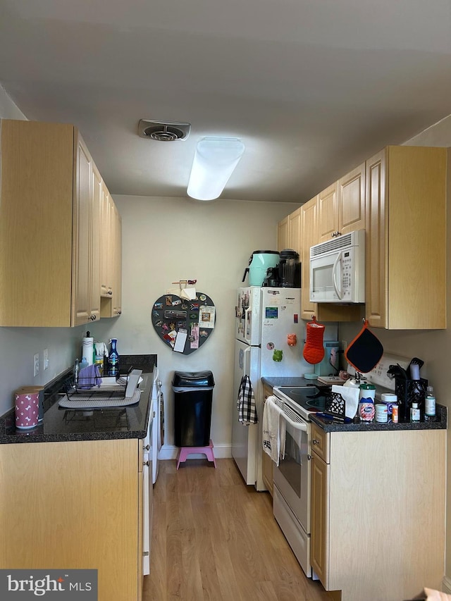 5601 Parker House Ter Unit 407, Hyattsville, MD 20782 - kitchen featuring white appliances, light brown cabinets, light wood-style floors, baseboards, and visible vents