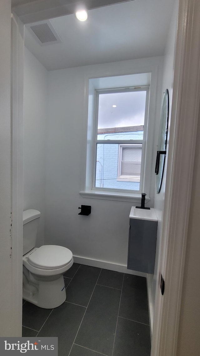 bathroom with toilet and tile patterned flooring