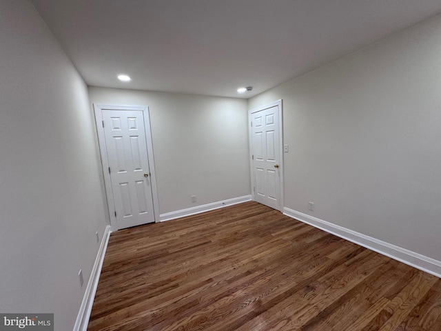 empty room featuring dark hardwood / wood-style flooring