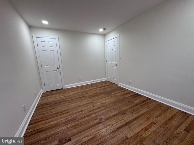 spare room featuring dark wood-type flooring