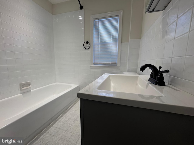 bathroom with vanity and tile walls