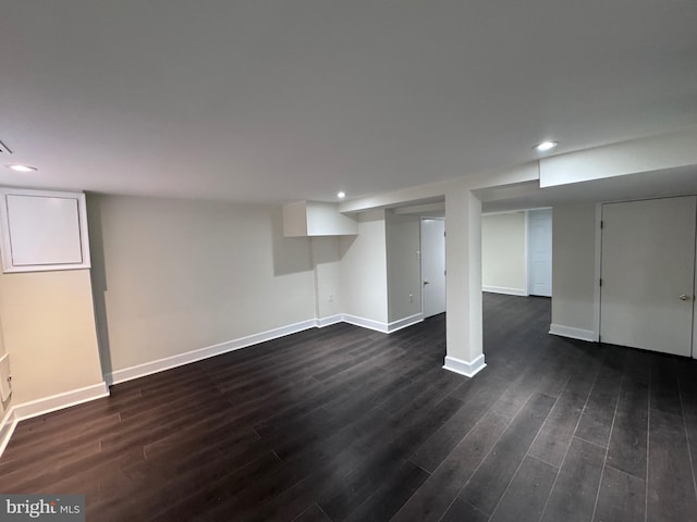 basement with dark hardwood / wood-style flooring