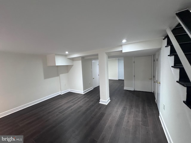 basement featuring dark hardwood / wood-style flooring