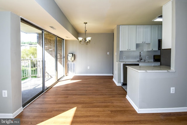 kitchen featuring white cabinetry, backsplash, a healthy amount of sunlight, and dark hardwood / wood-style floors