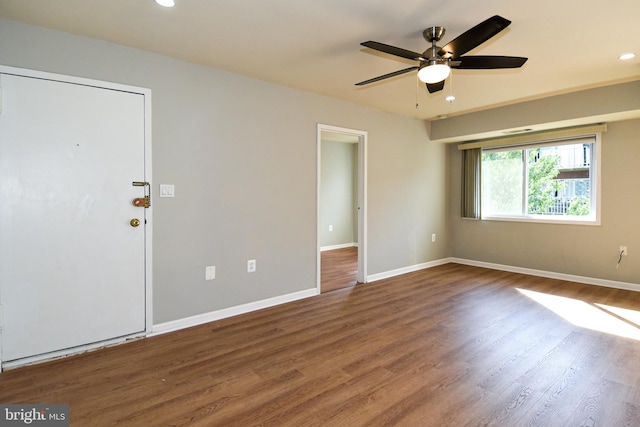 unfurnished room with dark wood-type flooring and ceiling fan