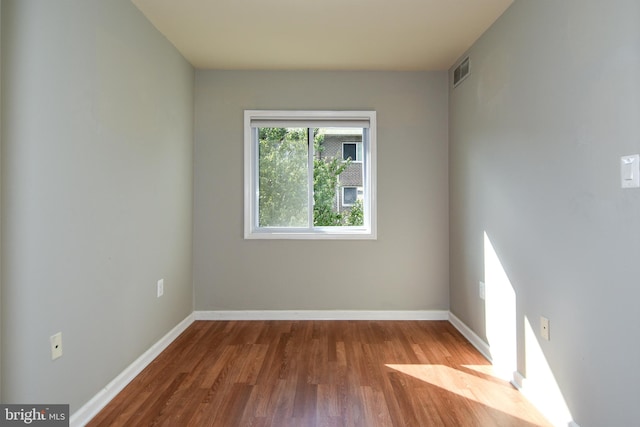 unfurnished room featuring hardwood / wood-style floors