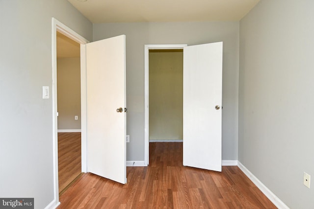 unfurnished bedroom with a closet and wood-type flooring