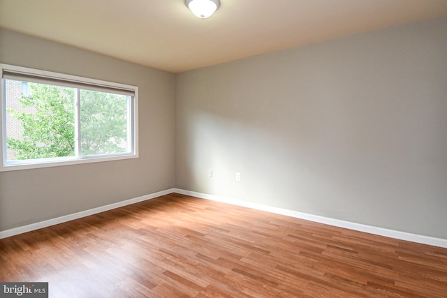 unfurnished room featuring hardwood / wood-style flooring