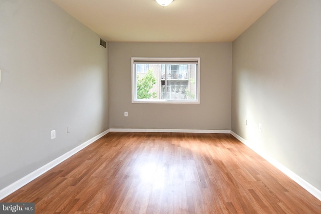 spare room featuring light wood-type flooring