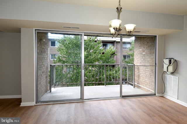 entryway with an inviting chandelier and hardwood / wood-style floors