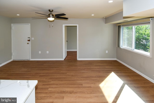 unfurnished room with wood-type flooring and ceiling fan