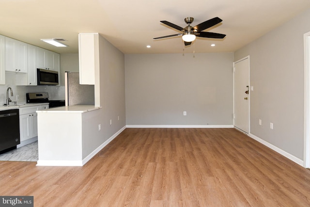 kitchen featuring appliances with stainless steel finishes, white cabinetry, and light wood-type flooring