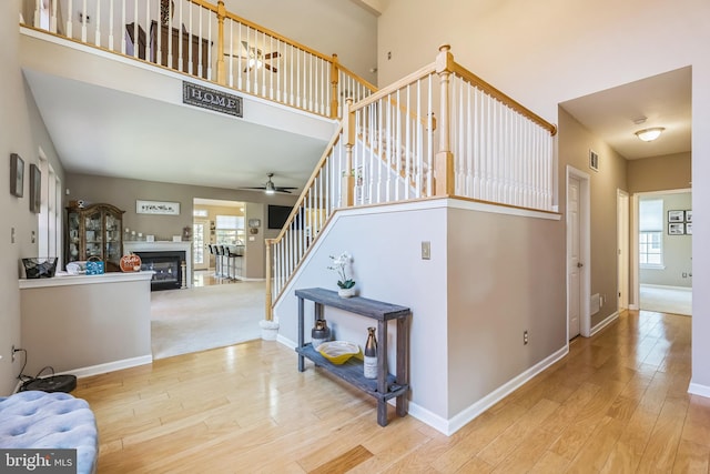 stairway featuring hardwood / wood-style floors and ceiling fan