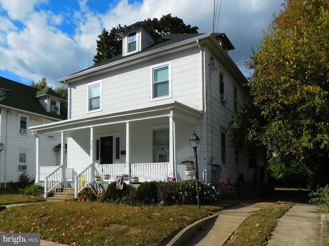 view of front facade featuring a porch and cooling unit