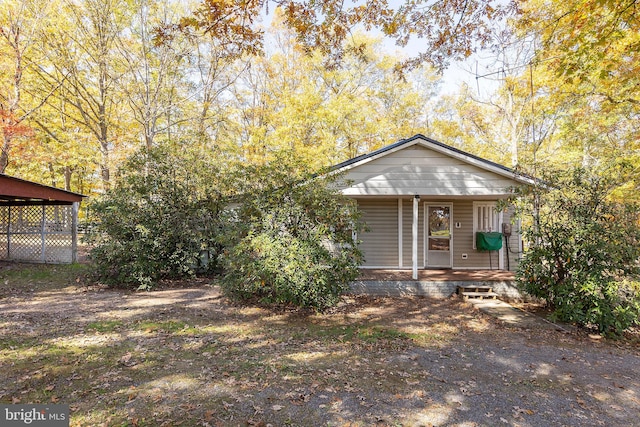 view of front of home with a porch and a carport