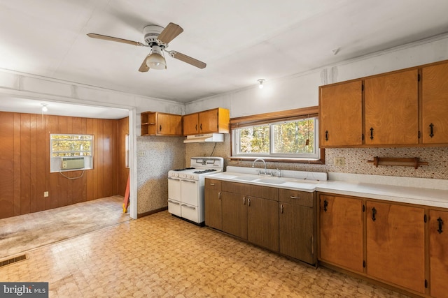 kitchen featuring white range, sink, cooling unit, and ceiling fan