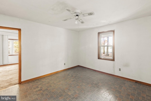 spare room with a healthy amount of sunlight and ceiling fan