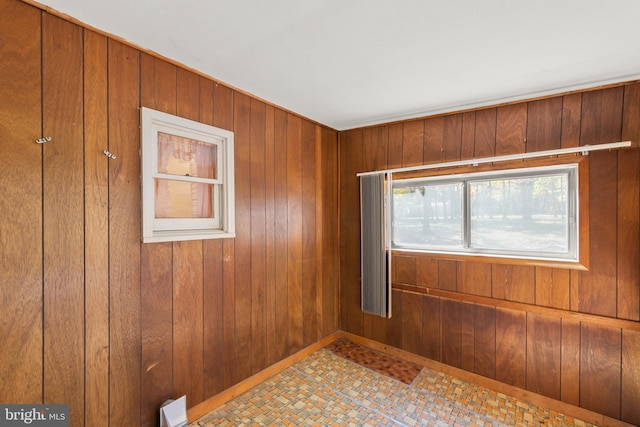 empty room featuring wooden walls