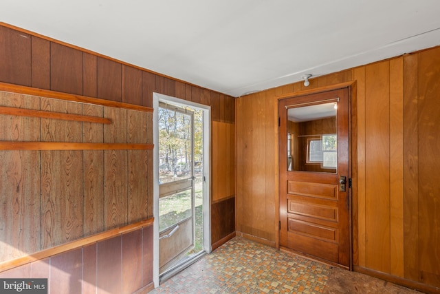 entryway with wooden walls