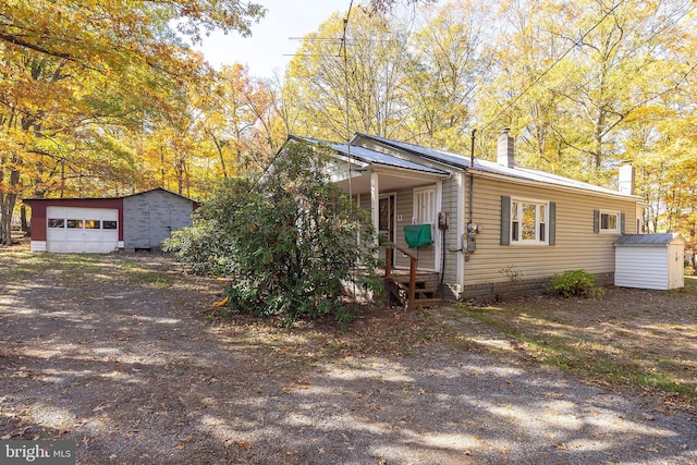 single story home with a storage shed and a garage