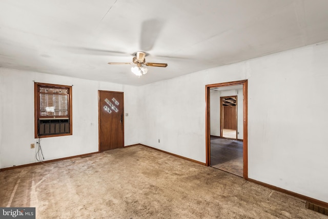 carpeted empty room featuring ceiling fan and cooling unit