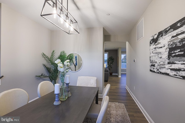 dining area with dark hardwood / wood-style flooring